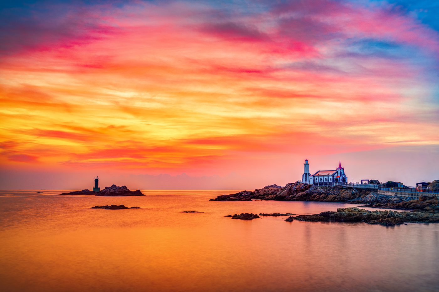Busan coast at sunrise, lighthouse and rocky headland